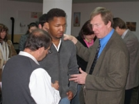 Pedro and Robert ministering to young man